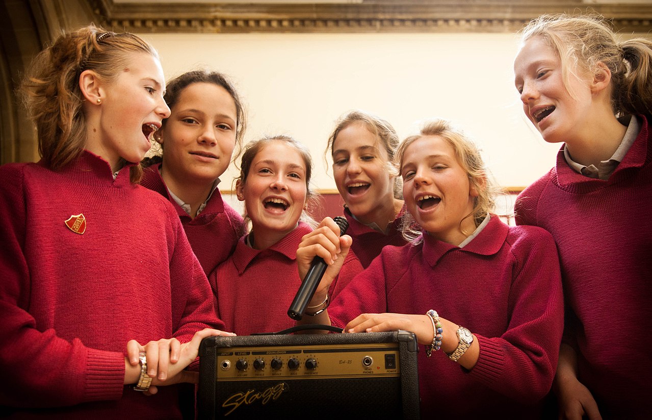 Girls singing with a microphone